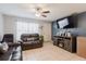 A comfortable living room with leather furniture, a television, and tile flooring at 8517 N Branch Ave, Tampa, FL 33604