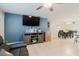 Open-concept living space featuring tile floors, a dining area, and a modern entertainment center at 8517 N Branch Ave, Tampa, FL 33604