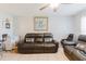 Inviting living room with comfortable seating, a ceiling fan, and a decorative painting at 8517 N Branch Ave, Tampa, FL 33604
