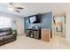 A cozy living room with a large television, a neutral paint, tile flooring, and an entryway at 8517 N Branch Ave, Tampa, FL 33604