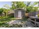 This backyard shed offers great additional storage with a white door and adjacent picnic table at 8517 N Branch Ave, Tampa, FL 33604