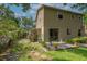 Spacious backyard with an open patio area featuring sliding door access and green grass at 9465 126Th Ave, Largo, FL 33773