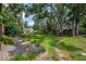 Expansive backyard with wooden deck, a large lawn, mature trees, and a serene setting at 9465 126Th Ave, Largo, FL 33773