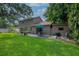 Large backyard with a lush lawn, an outdoor dining area, and well-manicured landscaping at 9465 126Th Ave, Largo, FL 33773