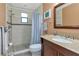 Bathroom features decorative mirror, granite countertop vanity and tiled walk-in shower at 9465 126Th Ave, Largo, FL 33773