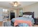 Bedroom features a ceiling fan, wood flooring, and large mirror closet at 9465 126Th Ave, Largo, FL 33773