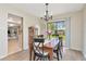 Stylish dining room featuring wood floors, a modern chandelier, and sliding glass doors to the backyard at 9465 126Th Ave, Largo, FL 33773