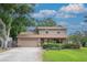 Charming two-story home featuring a brick facade, well-manicured lawn, and a welcoming two-car garage at 9465 126Th Ave, Largo, FL 33773