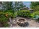 Inviting backyard fire pit area with seating is perfect for outdoor gatherings and cozy evenings at 9465 126Th Ave, Largo, FL 33773