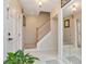 Warm foyer with tile flooring, wooden staircase, and a mirrored closet door at 9465 126Th Ave, Largo, FL 33773