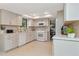 Modern kitchen showcasing white appliances, stylish countertops, and an open layout at 9465 126Th Ave, Largo, FL 33773