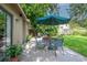 Outdoor patio seating area with an umbrella provides an intimate space for relaxation and entertaining guests at 9465 126Th Ave, Largo, FL 33773