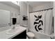 Modern bathroom with black and white decor, vanity, and shower-tub combo at 9720 Hound Chase Dr, Gibsonton, FL 33534