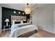Comfortable bedroom with a green accent wall, natural lighting and stylish decor at 9720 Hound Chase Dr, Gibsonton, FL 33534