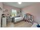 Pink bedroom with window, decorated shelves, desk, and dollhouse adds charm at 9720 Hound Chase Dr, Gibsonton, FL 33534