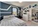 Blue-walled bedroom featuring a desk area, shelving and modern decor at 9720 Hound Chase Dr, Gibsonton, FL 33534