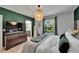 Cozy bedroom with hardwood floors, stylish decor, and a view into the bathroom at 9720 Hound Chase Dr, Gibsonton, FL 33534