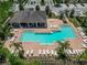 An aerial shot shows the community pool area with ample seating, palm trees, and a nearby pavilion at 9720 Hound Chase Dr, Gibsonton, FL 33534