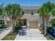 Charming townhome with a one car garage and beautiful palm tree landscaping at 9720 Hound Chase Dr, Gibsonton, FL 33534