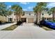 Attractive townhome with an attached garage, a charming entryway and mature landscaping at 9720 Hound Chase Dr, Gibsonton, FL 33534