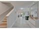 Bright foyer with staircase leading to the open-concept living and dining area at 9720 Hound Chase Dr, Gibsonton, FL 33534