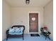 Inviting front porch with seating, a wreath on the door, and decor at 9720 Hound Chase Dr, Gibsonton, FL 33534