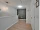 Well-lit hallway featuring wood floors, neutral walls and decorative accent wall at 9720 Hound Chase Dr, Gibsonton, FL 33534