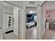 Hallway view to a bedroom and bathroom showcasing the home's layout at 9720 Hound Chase Dr, Gibsonton, FL 33534