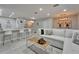 Bright living space with an open floor plan, a kitchen bar, and a comfortable seating area at 9720 Hound Chase Dr, Gibsonton, FL 33534