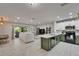 Open-concept living space with a stylish kitchen, dining area, and inviting living room at 9720 Hound Chase Dr, Gibsonton, FL 33534