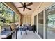 Screened patio with grill, dining table, seating, and slider to interior at 9720 Hound Chase Dr, Gibsonton, FL 33534