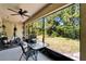Screened patio with exercise equipment, dining set, and backyard view at 9720 Hound Chase Dr, Gibsonton, FL 33534