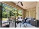 Screened patio with grill, dining table, and cozy seating area at 9720 Hound Chase Dr, Gibsonton, FL 33534