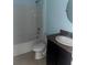 Bathroom with a tub-shower combination and a single sink vanity with dark cabinets at 9833 Hound Chase Dr, Gibsonton, FL 33534