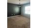 Bedroom with a dark accent wall, a ceiling chandelier and natural light, creating a calming atmosphere at 9833 Hound Chase Dr, Gibsonton, FL 33534
