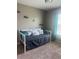 Cozy bedroom with a comfortable daybed and a large window offering plenty of natural light at 9833 Hound Chase Dr, Gibsonton, FL 33534