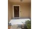 Inviting entryway featuring a covered porch, a welcome mat and privacy landscaping at 9833 Hound Chase Dr, Gibsonton, FL 33534