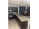 Modern kitchen featuring granite countertops, stainless steel appliances and dark cabinetry at 9833 Hound Chase Dr, Gibsonton, FL 33534