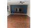 Spacious living room with hardwood floors and media center, perfect for relaxing and entertaining at 9833 Hound Chase Dr, Gibsonton, FL 33534