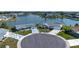 Aerial view of a home located on a waterfront lot in a quiet neighborhood at 1009 Andover Cir, Sun City Center, FL 33573