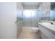 The bathroom features a vanity with sink, toilet, and a shower and tub combo with sliding glass doors at 1009 Andover Cir, Sun City Center, FL 33573