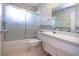 This bathroom features a sink, toilet, and a shower-tub combo with a sliding glass door at 1009 Andover Cir, Sun City Center, FL 33573