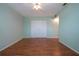 Neutral bedroom with laminate floors, a ceiling fan, and double door closet at 1009 Andover Cir, Sun City Center, FL 33573