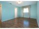 View of bedroom with light blue walls, hardwood floors, and natural light at 1009 Andover Cir, Sun City Center, FL 33573