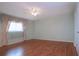 Light-filled bedroom with hardwood floors and a ceiling fan at 1009 Andover Cir, Sun City Center, FL 33573
