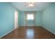 Spacious bedroom with neutral walls, hardwood floors, and a ceiling fan at 1009 Andover Cir, Sun City Center, FL 33573
