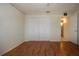 Bright bedroom featuring wood floors, and a closet; perfect for a relaxing retreat at 1009 Andover Cir, Sun City Center, FL 33573