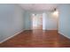 Bright bedroom with laminate floors with open door leading to another bedroom at 1009 Andover Cir, Sun City Center, FL 33573