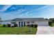 Inviting single-story home with a two car garage, mature landscaping and lush grass at 1009 Andover Cir, Sun City Center, FL 33573
