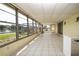 Bright enclosed Florida room offering panoramic views of the lake and backyard at 1009 Andover Cir, Sun City Center, FL 33573